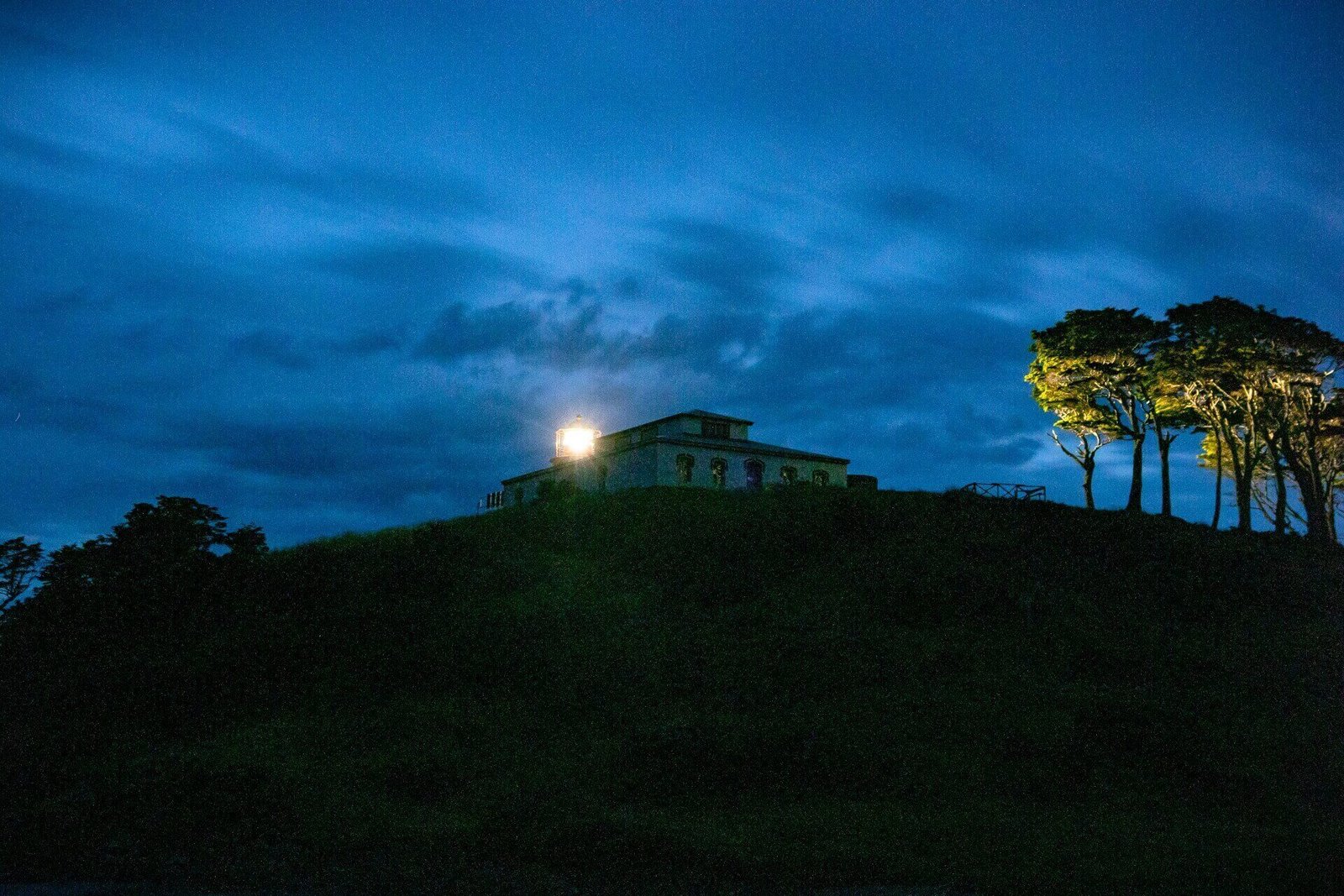 Faro San Isidro lighthouse at dusk by the Strait of Magellan
